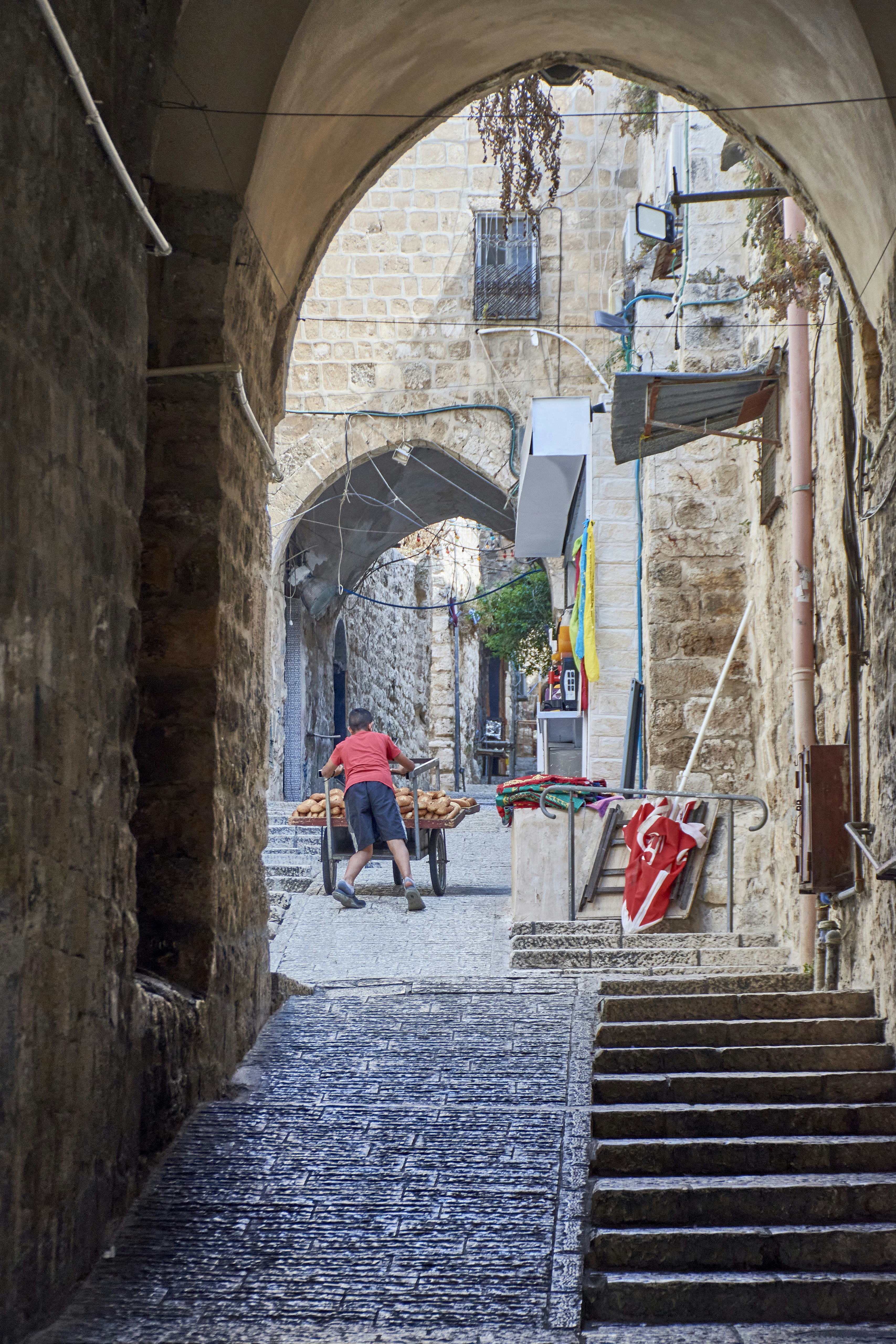 a man sitting on a chair in an alley way