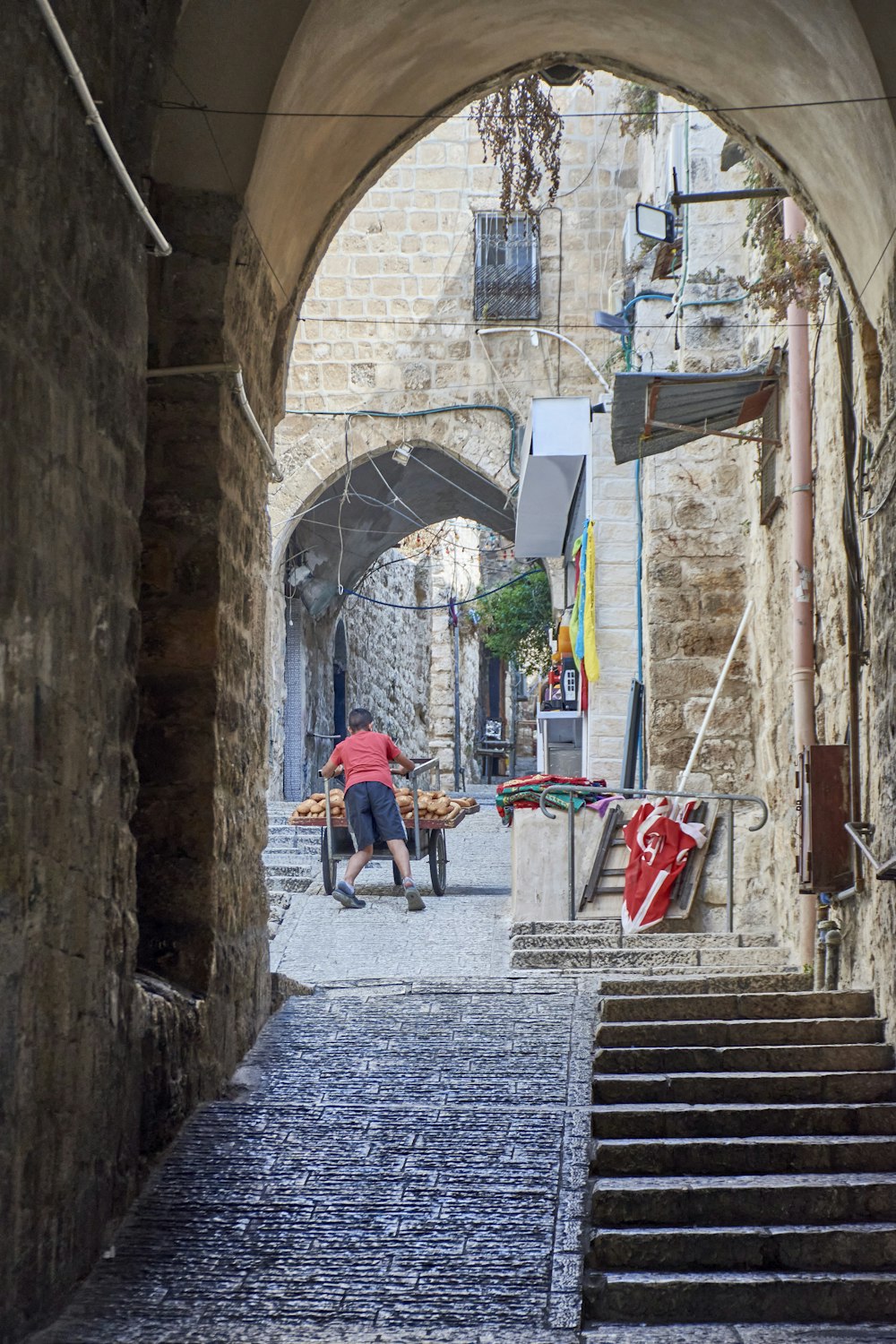 a man sitting on a chair in an alley way