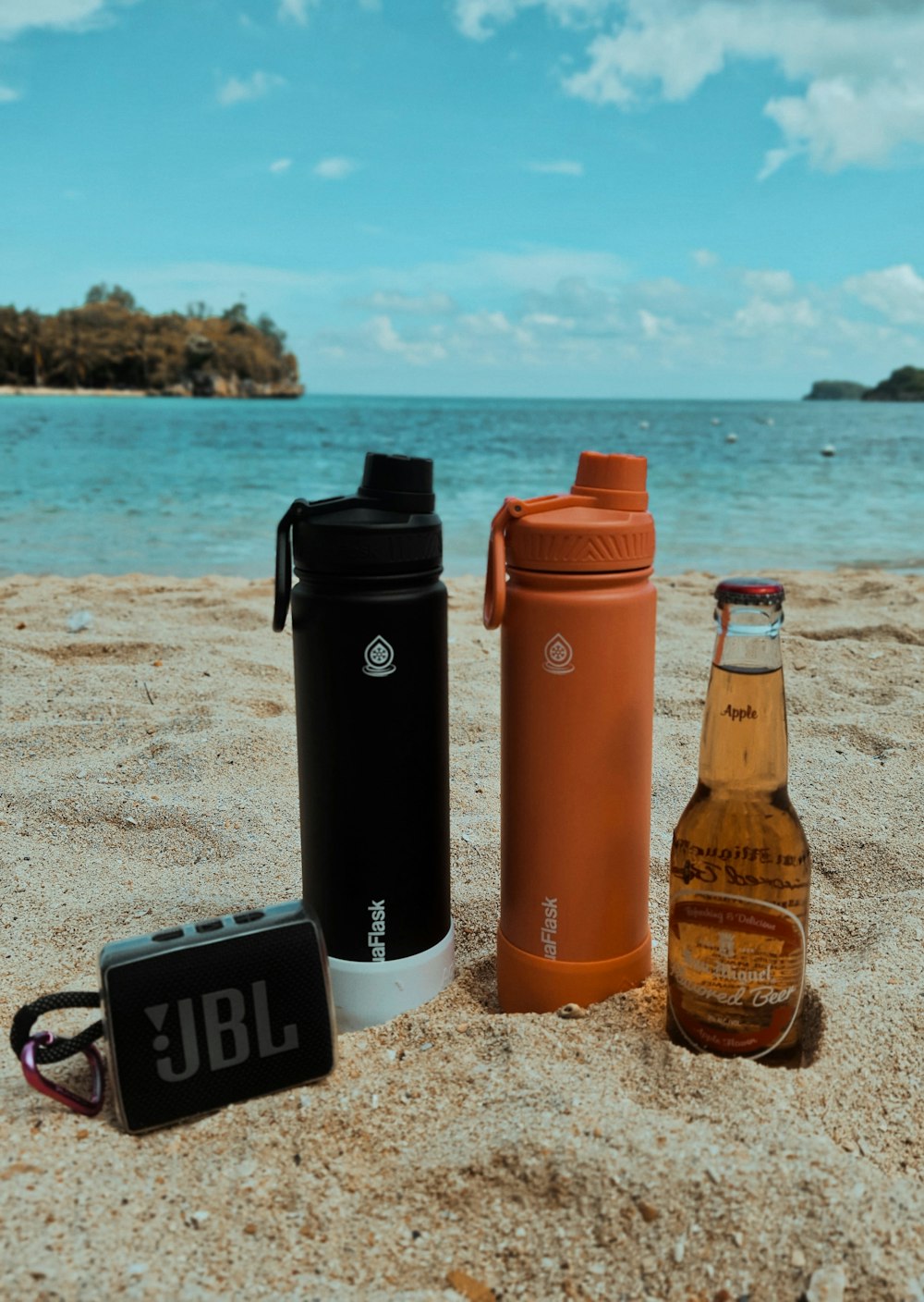 a bottle of beer and a bottle of beer on the beach