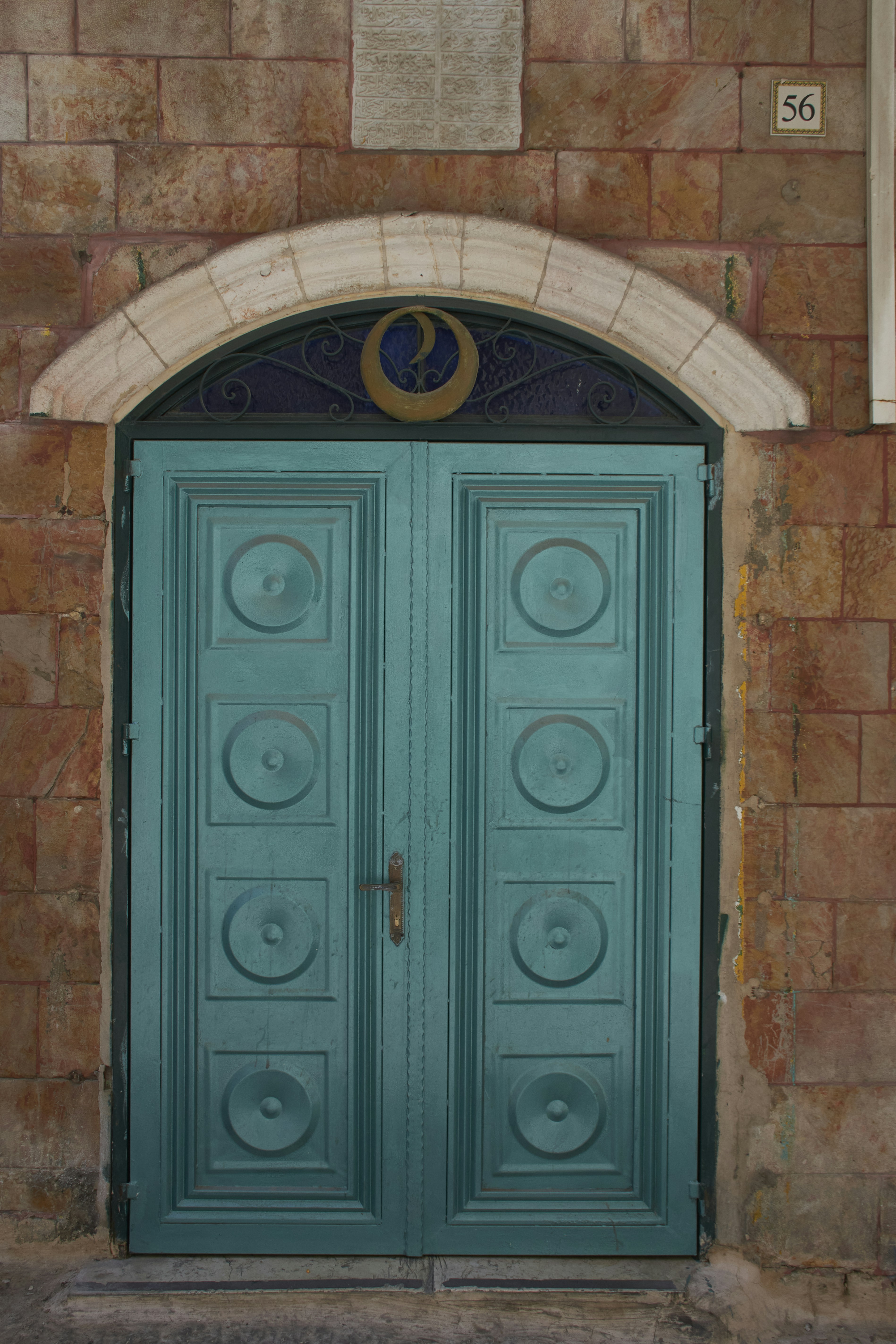 a blue door with a clock on the side of it