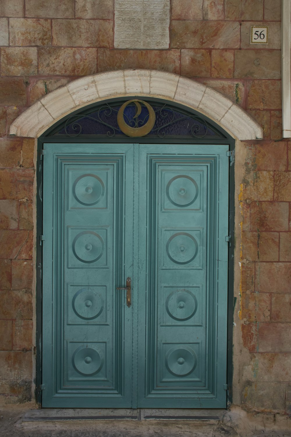 a blue door with a clock on the side of it