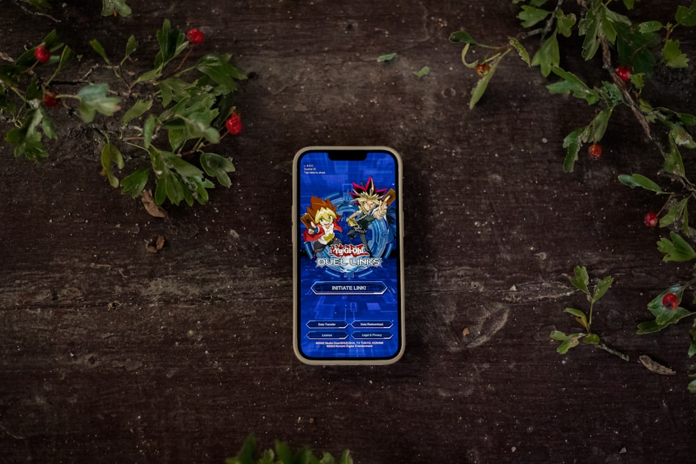 a cell phone sitting on top of a wooden table