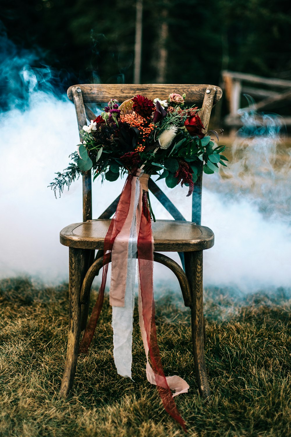 a wooden chair with a bouquet of flowers on top of it