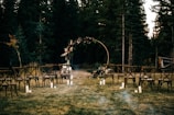 A romantic outdoor wedding setup with fairy lights and floral arches.
