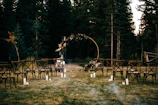 A charming outdoor wedding setup with rustic wooden accents and fairy lights.
