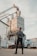 A satisfied customer standing next to well-maintained industrial equipment.