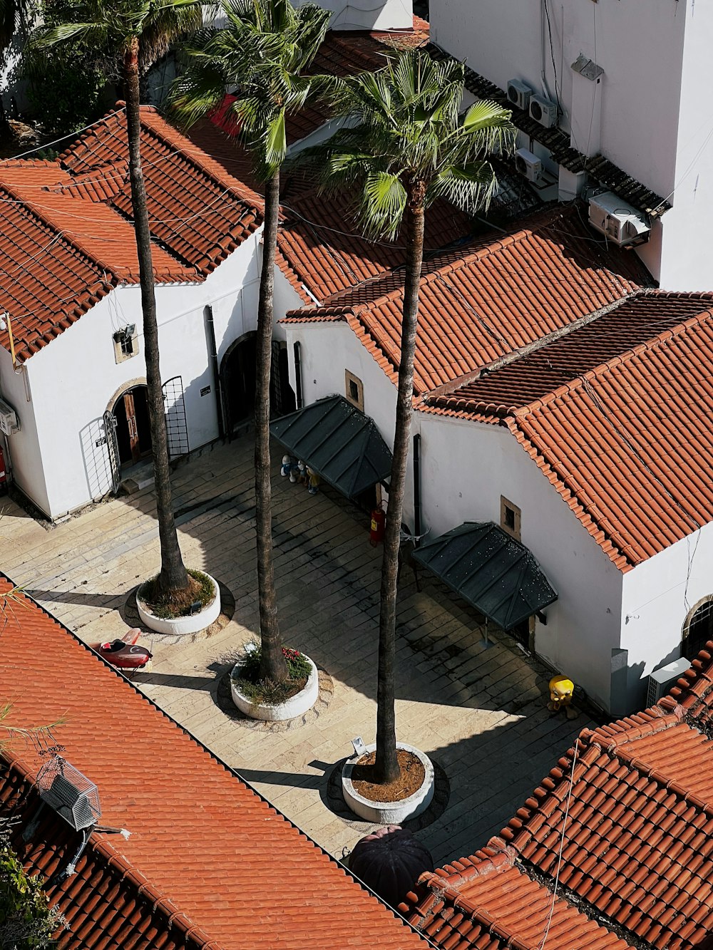 an aerial view of a building with palm trees