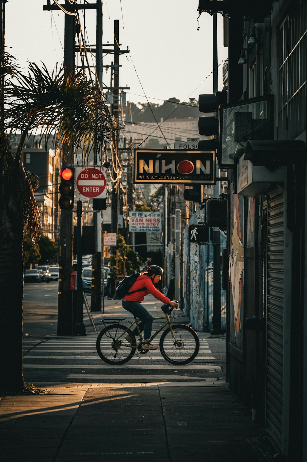 a person riding a bike on a city street