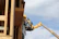 Close-up of a Youxi scissor lift platform with a worker wearing safety gear.