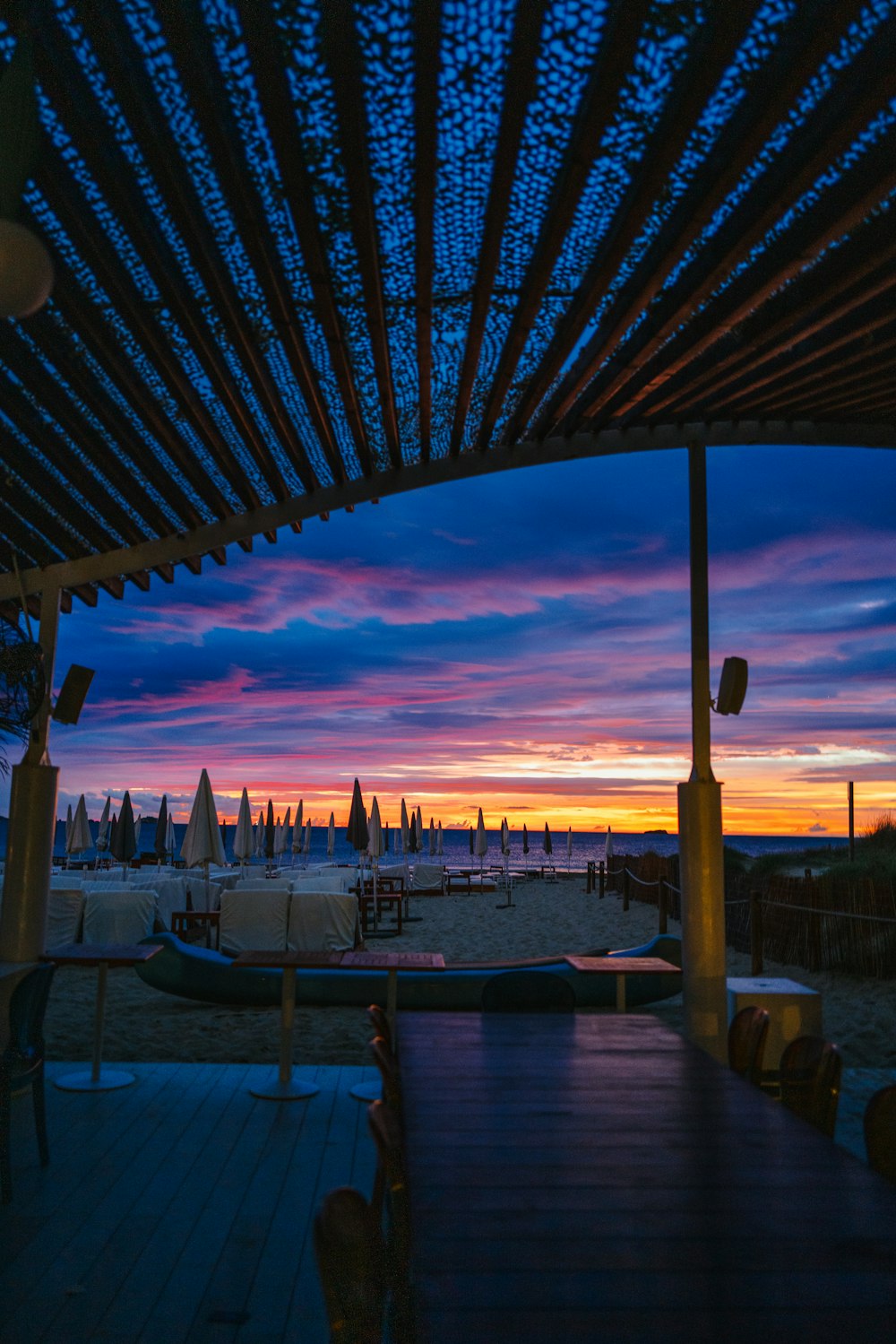 a view of a beach at sunset from a restaurant