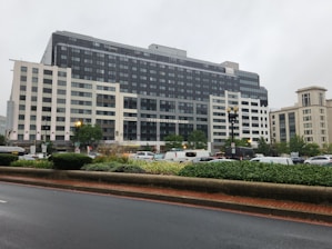 A fleet of company vehicles parked outside a corporate building.