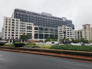 A fleet of company vehicles parked outside a corporate building.
