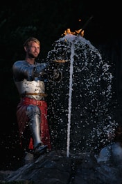 Dynamic battle scene with heroes clashing swords amid magical effects in a digital arena.