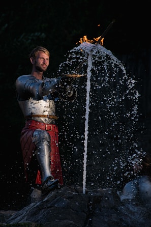 Close-up of a Stormwash character wielding a glowing sword amid rain.