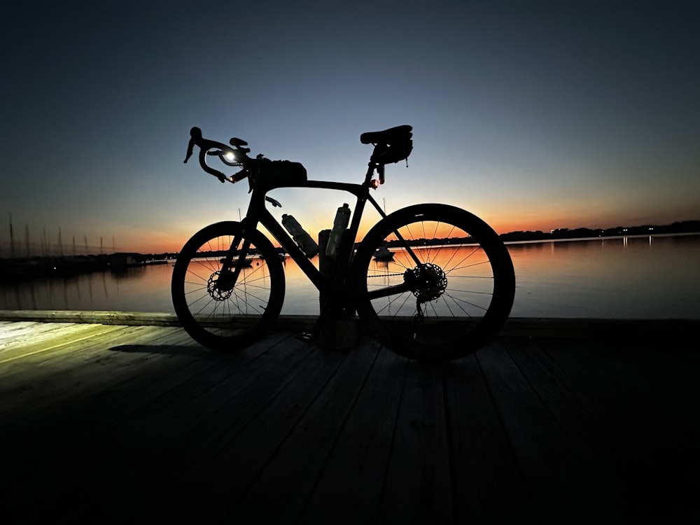 a bike is parked on a wooden dock