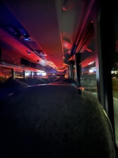 Close-up of a sleek party bus interior featuring colorful LED lights and plush seating.