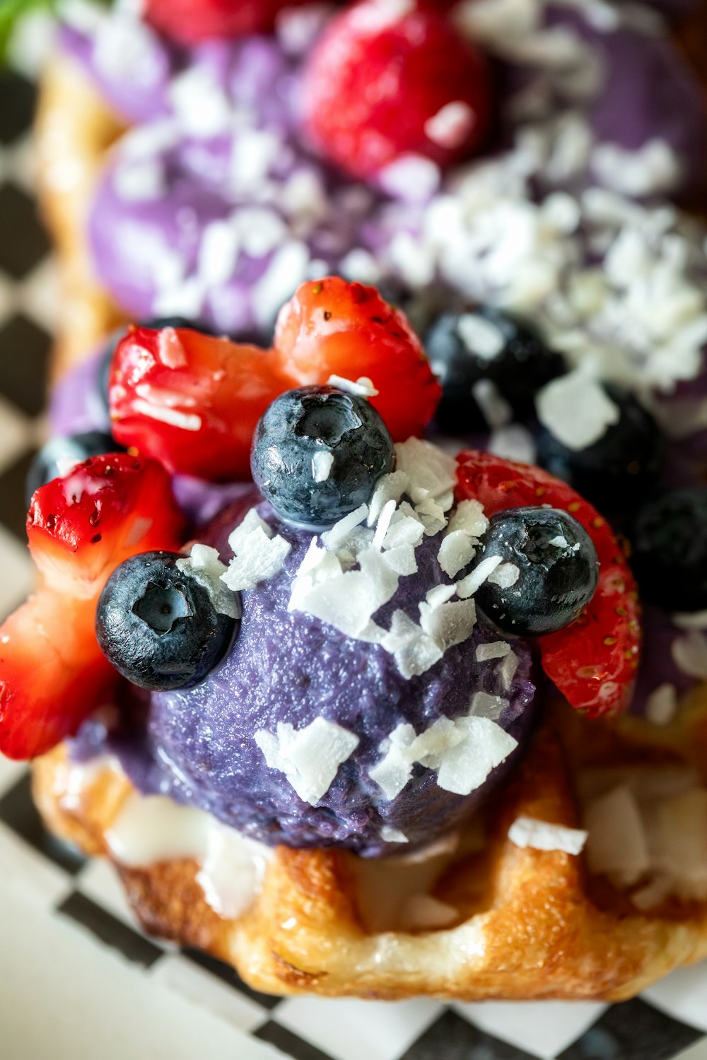 a waffle topped with berries and blueberries