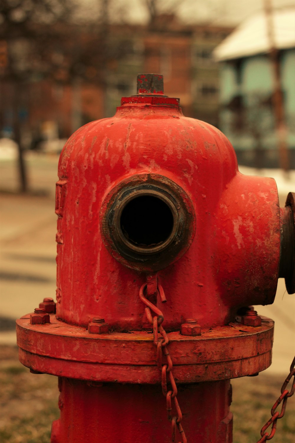 a red fire hydrant sitting on the side of a road