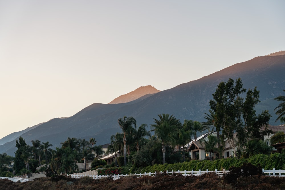 a view of a mountain range with a house in the foreground