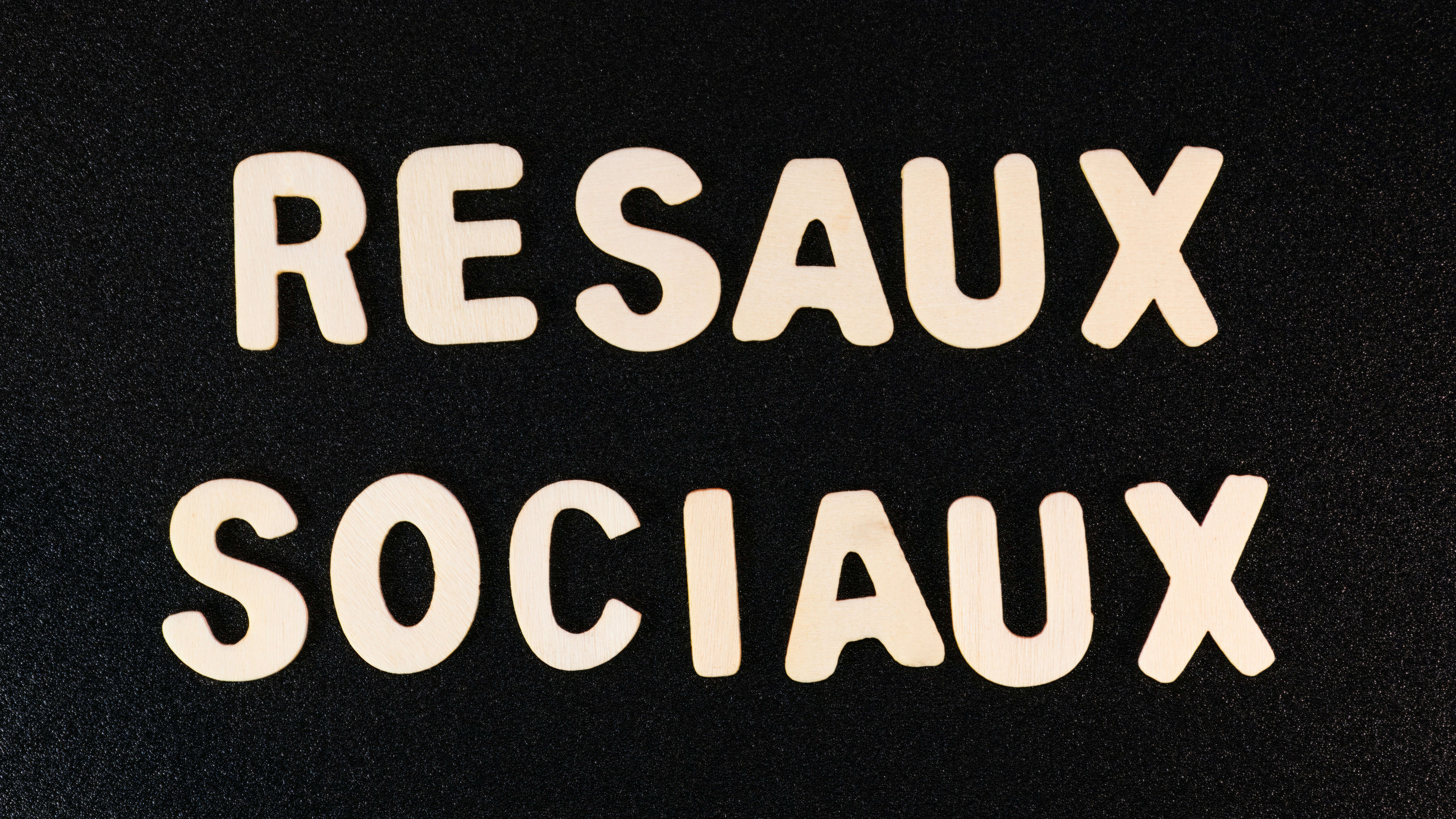 a close up of two white letters on a black surface