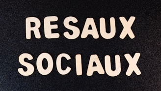 a close up of two white letters on a black surface