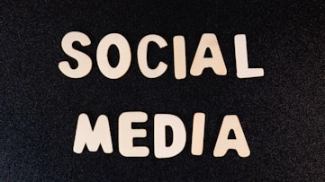 Block letters spelling 'SOCIAL MEDIA' arranged on a dark textured background.