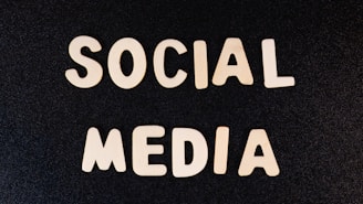 Block letters spelling 'SOCIAL MEDIA' arranged on a dark textured background.