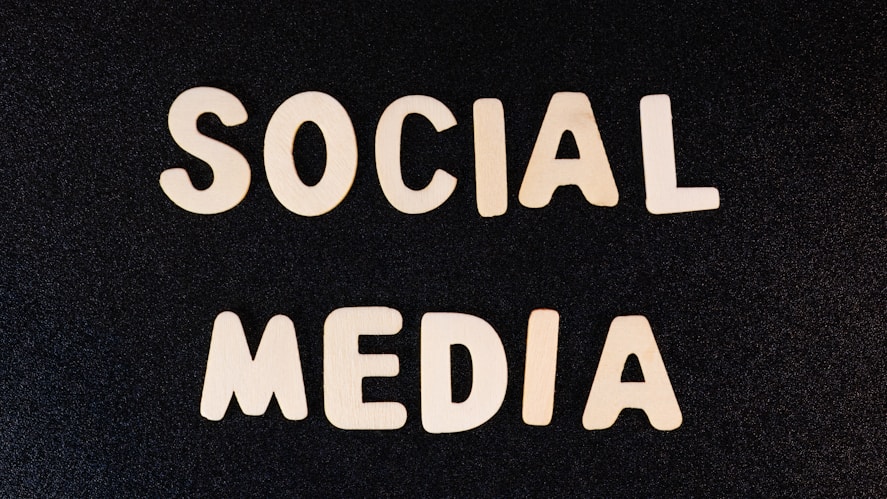 Block letters spelling 'SOCIAL MEDIA' arranged on a dark textured background.