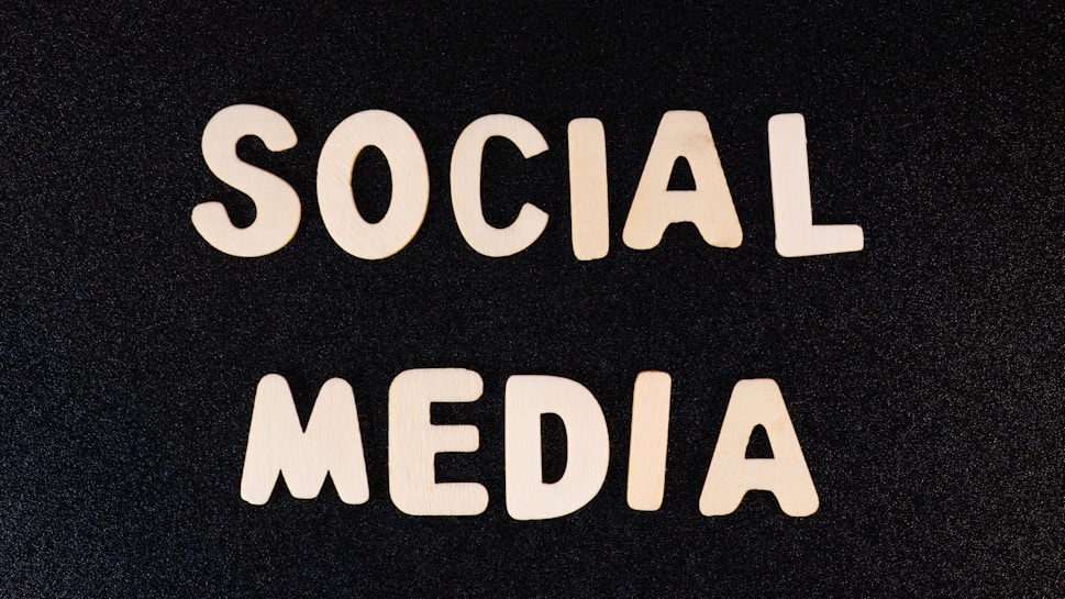 Block letters spelling 'SOCIAL MEDIA' arranged on a dark textured background.