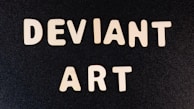 The image features bold, white letters spelling out 'DEVIANT ART' against a solid black background, arranged in two lines.