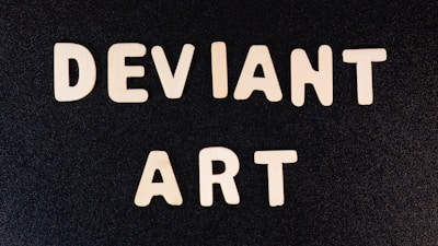 The image features bold, white letters spelling out 'DEVIANT ART' against a solid black background, arranged in two lines.