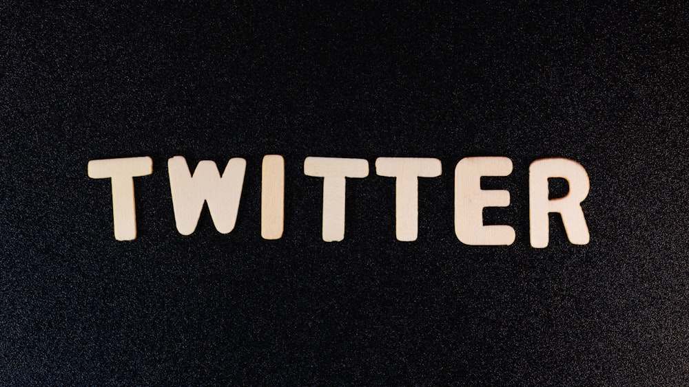 the word twitter spelled with white letters on a black background