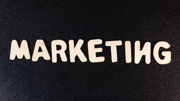 Wooden letters spelling MARKETING on a black background