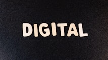 The word 'DIGITAL' is displayed in bold white letters against a plain black background.