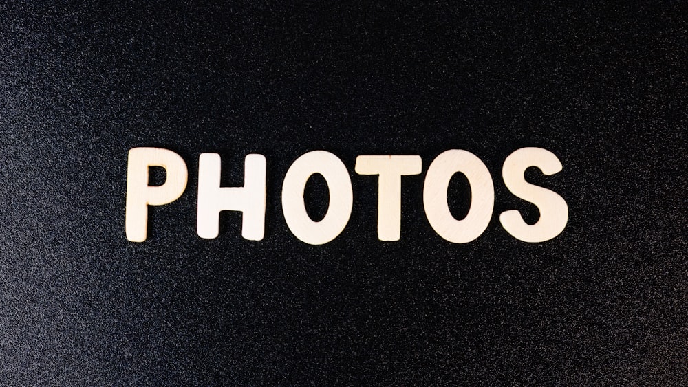 a close up of the word photos on a black surface