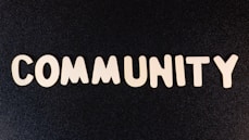 the word community written in white on a black background