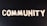 The word 'COMMUNITY' is spelled out with white wooden letters on a dark black background.