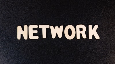 a close up of the word network on a black surface