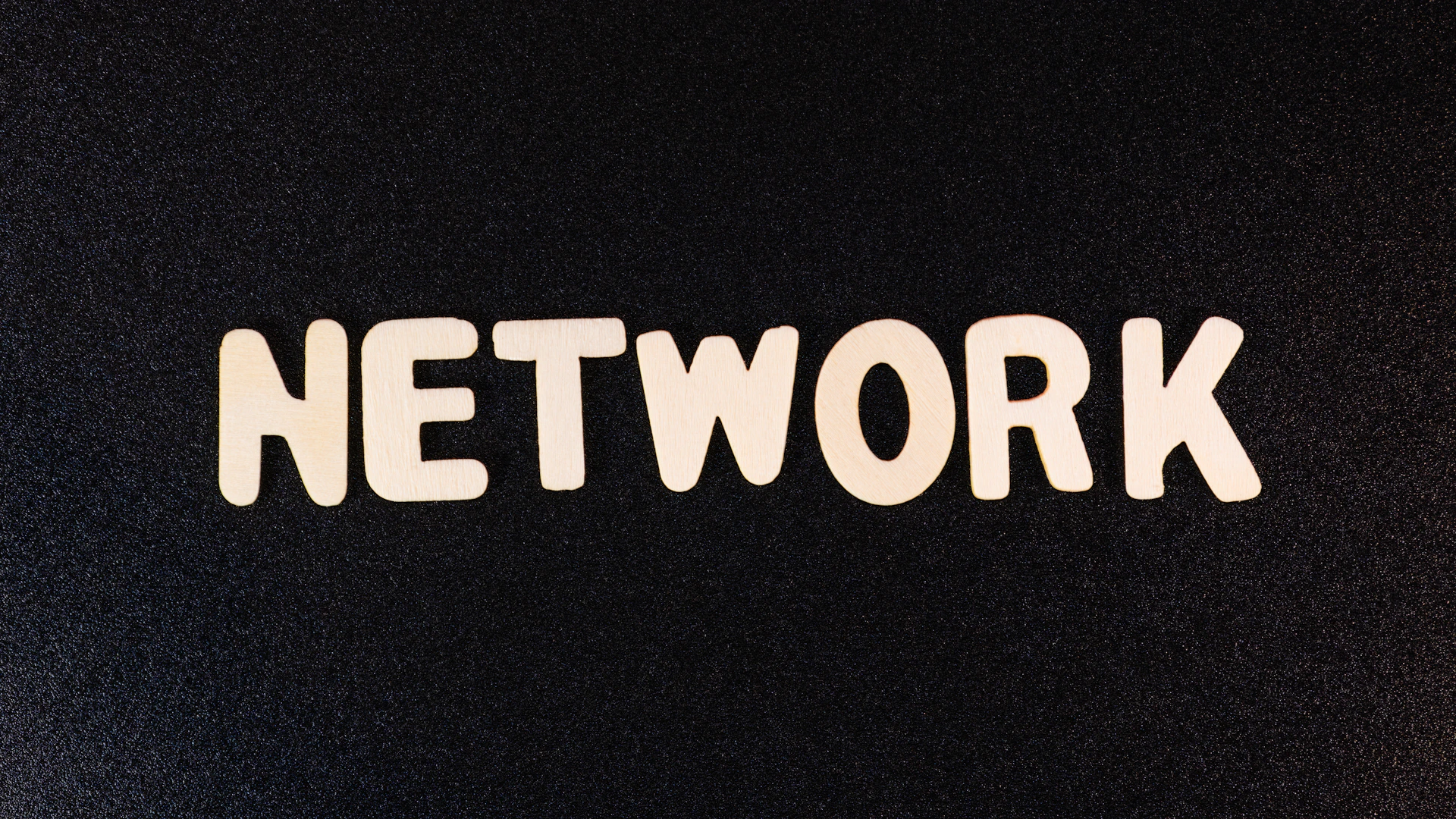 a close up of the word network on a black surface