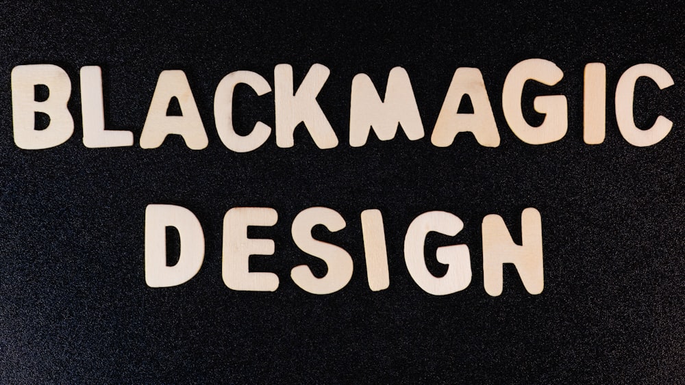 the words blackmagic design are cut out of white paper