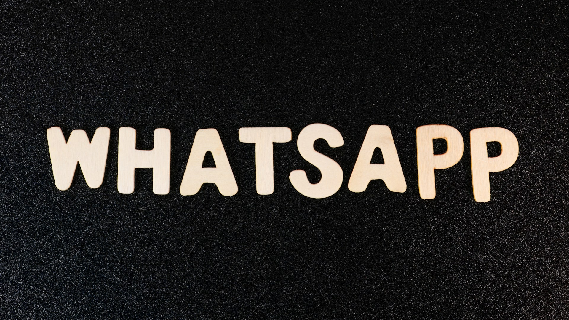 the word whatsapp written in white type on a black background