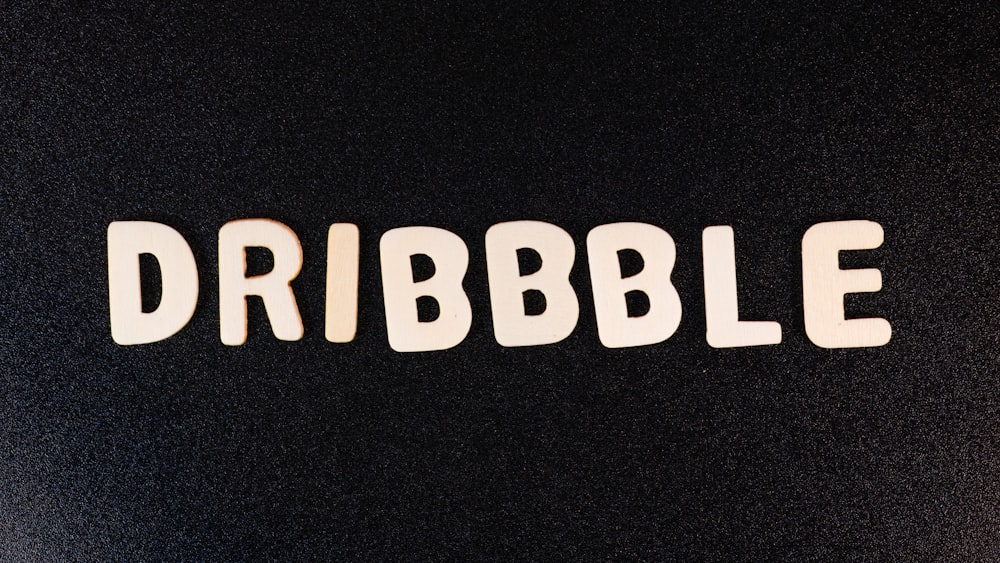 the word dribbble written in white letters on a black background