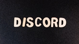 The image features the word 'DISCORD' in large, bold white letters against a dark background, resembling a chalkboard or textured surface.