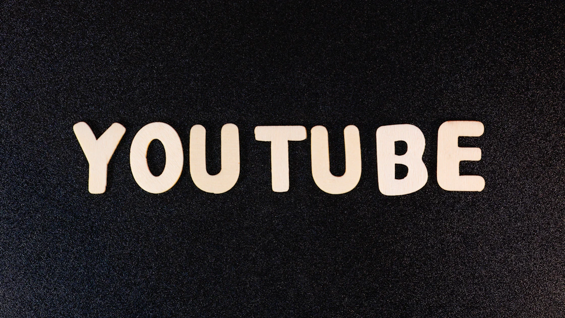 a close up of the word youtube on a black background