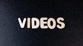 a close up of the word videos on a black background