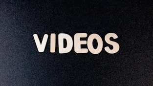 a close up of the word videos on a black background