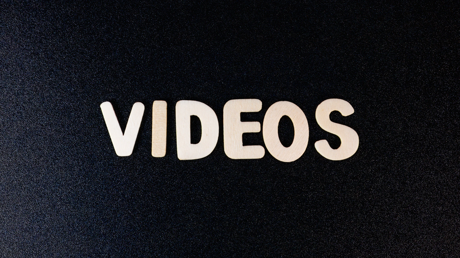 a close up of the word videos on a black background