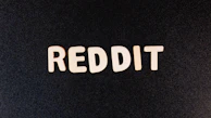 The word 'REDDIT' is spelled out in white capital letters against a textured black background.