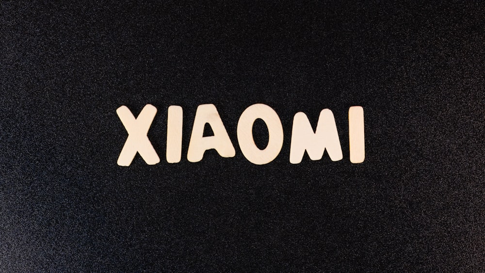 a close up of the word imoaix on a black surface