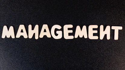 the word management written in white letters on a black background